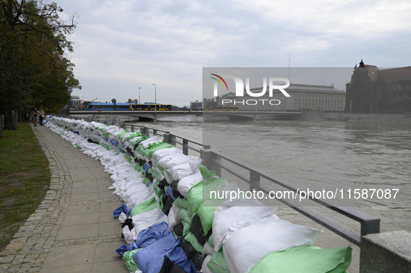 Sandbags sit against the river banks during high waters in the Oder River in Wroclaw, Poland, on September 19, 2024. 