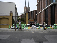 People walk next to sandbags during high waters in the Oder River in Wroclaw, Poland, on September 19, 2024. (