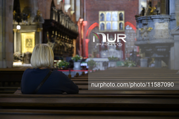 A woman prays in a church in Wroclaw, Poland, on September 19, 2024. 