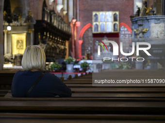 A woman prays in a church in Wroclaw, Poland, on September 19, 2024. (