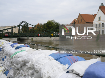 Sandbags sit against the river banks during high waters in the Oder River in Wroclaw, Poland, on September 19, 2024. (