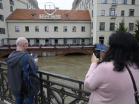 People take pictures of the Oder during high waters in the Oder River in Wroclaw, Poland, on September 19, 2024. (