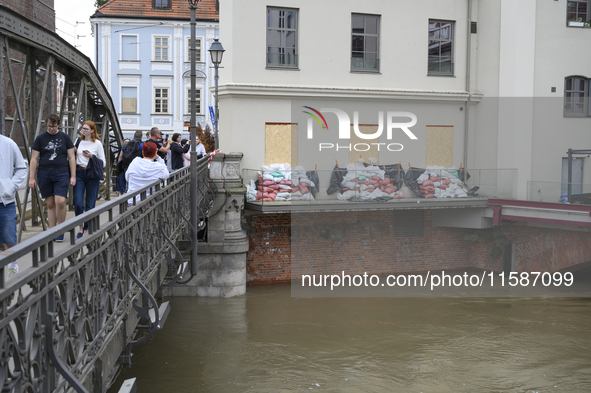 People take pictures from a bridge during high waters in the Oder River in Wroclaw, Poland, on September 19, 2024. 