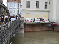 People take pictures from a bridge during high waters in the Oder River in Wroclaw, Poland, on September 19, 2024. (