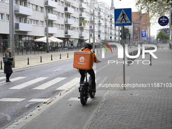 A food delivery courier rides his bike in Wroclaw, Poland, on September 19, 2024. (