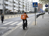 A food delivery courier rides his bike in Wroclaw, Poland, on September 19, 2024. (