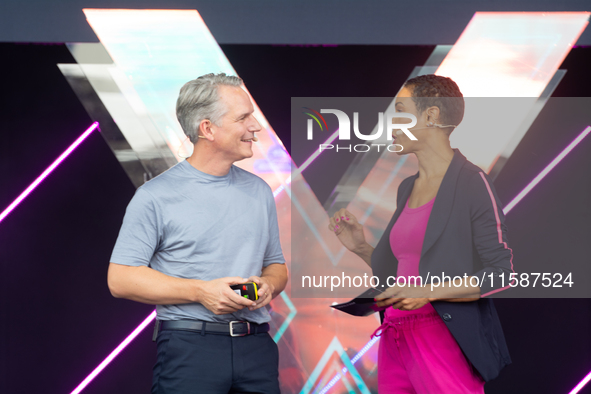 Peter Koerte, Chief Technology and Chief Strategy Officer of Siemens AG, and Annabelle Mandeng, a German actress, speak at Media Park on the...