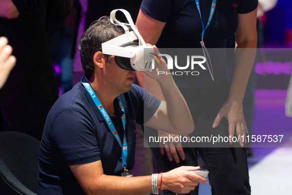 People try on VR sets on the second day of Deutsche Telekom's Digital X event at Media Park in Cologne, Germany, on September 18, 2024. 