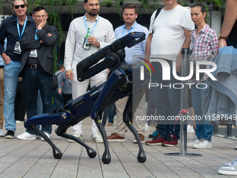 A robot dog walks at Media Park on the second day of Deutsche Telekom's Digital X event in Cologne, Germany, on September 18, 2024. (