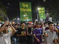 Protesters hold placards during the protest in Dhaka, Bangladesh, on September 19, 2024, against Bengali settler attacks on the Indigenous c...