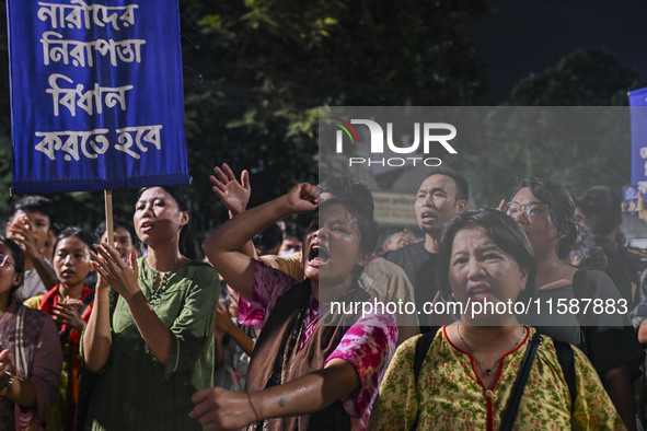 Protesters hold placards during the protest in Dhaka, Bangladesh, on September 19, 2024, against Bengali settler attacks on the Indigenous c...