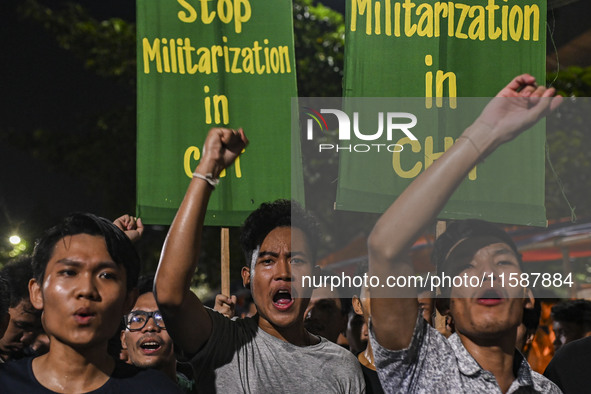 Protesters hold placards during the protest in Dhaka, Bangladesh, on September 19, 2024, against Bengali settler attacks on the Indigenous c...