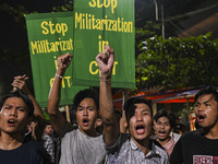 Protesters hold placards during the protest in Dhaka, Bangladesh, on September 19, 2024, against Bengali settler attacks on the Indigenous c...