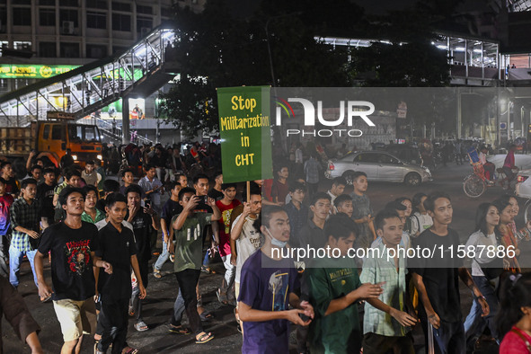 Protesters hold placards during the protest in Dhaka, Bangladesh, on September 19, 2024, against Bengali settler attacks on the Indigenous c...