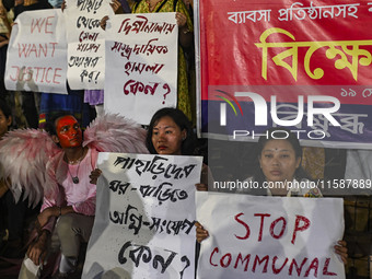 Protesters hold placards during the protest in Dhaka, Bangladesh, on September 19, 2024, against Bengali settler attacks on the Indigenous c...