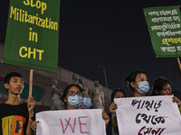 Protesters hold placards during the protest in Dhaka, Bangladesh, on September 19, 2024, against Bengali settler attacks on the Indigenous c...