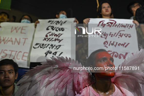 Protesters hold placards during the protest in Dhaka, Bangladesh, on September 19, 2024, against Bengali settler attacks on the Indigenous c...