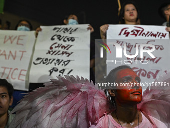 Protesters hold placards during the protest in Dhaka, Bangladesh, on September 19, 2024, against Bengali settler attacks on the Indigenous c...