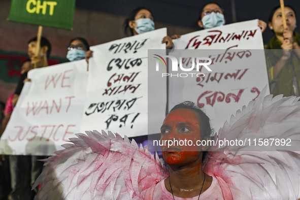 Protesters hold placards during the protest in Dhaka, Bangladesh, on September 19, 2024, against Bengali settler attacks on the Indigenous c...