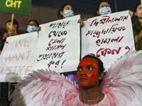 Protesters hold placards during the protest in Dhaka, Bangladesh, on September 19, 2024, against Bengali settler attacks on the Indigenous c...