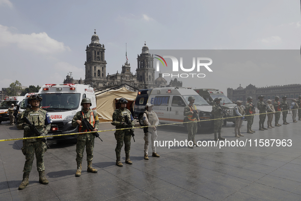 Members of the Mexican army guard the area during the National Drill 2024 in the Zocalo of Mexico City, Mexico, on September 19, 2024, to ev...