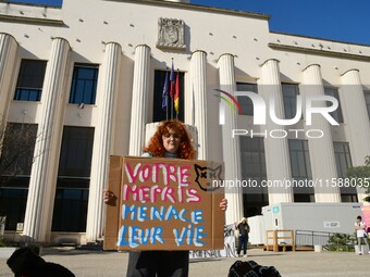 Protesters from the Ron Rhone association stand in front of the Villeurbanne town hall to urge the city's mayor to sterilize stray cats in V...