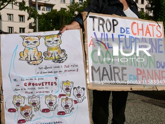 Protesters from the Ron Rhone association stand in front of the Villeurbanne town hall to urge the city's mayor to sterilize stray cats in V...