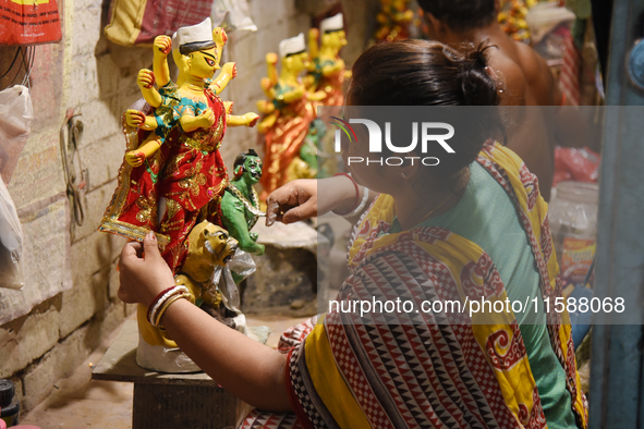 An artisan makes an idol of the Hindu Goddess Durga in Kumartuli, the potter's village in Kolkata, India, on September 20, 2024. The four-da...