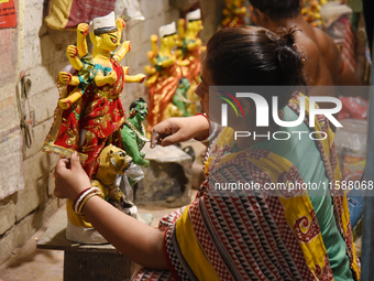 An artisan makes an idol of the Hindu Goddess Durga in Kumartuli, the potter's village in Kolkata, India, on September 20, 2024. The four-da...