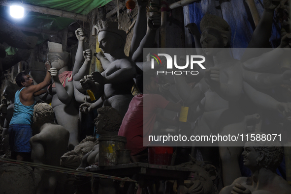 An artisan makes an idol of the Hindu Goddess Durga in Kumartuli, the potter's village in Kolkata, India, on September 20, 2024. The four-da...