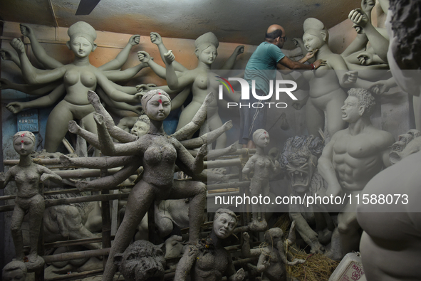 An artisan makes an idol of the Hindu Goddess Durga in Kumartuli, the potter's village in Kolkata, India, on September 20, 2024. The four-da...