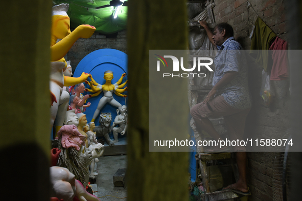 An artisan makes an idol of the Hindu Goddess Durga in Kumartuli, the potter's village in Kolkata, India, on September 20, 2024. The four-da...