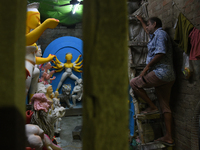 An artisan makes an idol of the Hindu Goddess Durga in Kumartuli, the potter's village in Kolkata, India, on September 20, 2024. The four-da...