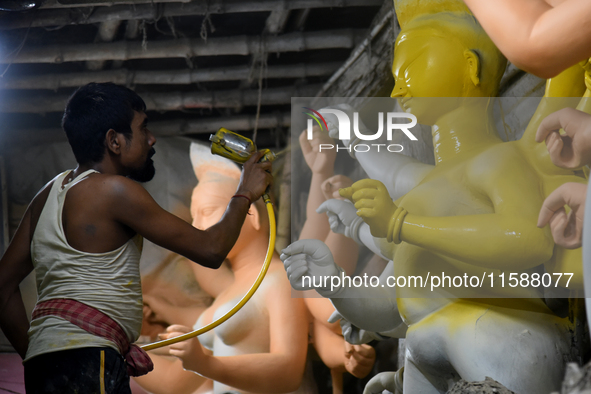 An artisan makes an idol of the Hindu Goddess Durga in Kumartuli, the potter's village in Kolkata, India, on September 20, 2024. The four-da...