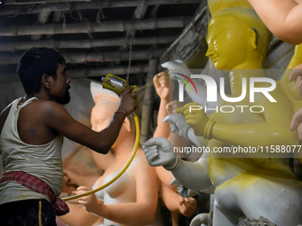 An artisan makes an idol of the Hindu Goddess Durga in Kumartuli, the potter's village in Kolkata, India, on September 20, 2024. The four-da...