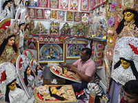 An artisan paints a decoration of the Hindu goddess Durga inside a shop ahead of the Durga Puja festival in Kolkata, India, on September 20,...