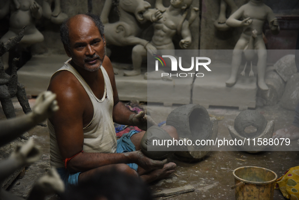 An artisan makes an idol of the Hindu Goddess Durga in Kumartuli, the potter's village in Kolkata, India, on September 20, 2024. The four-da...