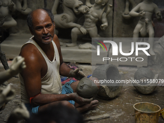 An artisan makes an idol of the Hindu Goddess Durga in Kumartuli, the potter's village in Kolkata, India, on September 20, 2024. The four-da...