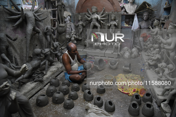 An artisan makes an idol of the Hindu Goddess Durga in Kumartuli, the potter's village in Kolkata, India, on September 20, 2024. The four-da...