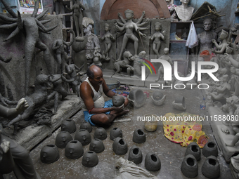 An artisan makes an idol of the Hindu Goddess Durga in Kumartuli, the potter's village in Kolkata, India, on September 20, 2024. The four-da...