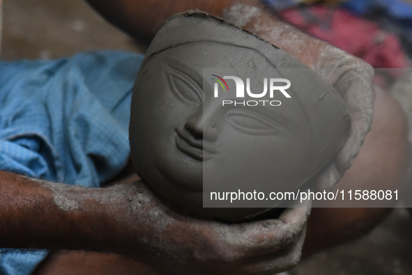 An artisan makes an idol of the Hindu Goddess Durga in Kumartuli, the potter's village in Kolkata, India, on September 20, 2024. The four-da...