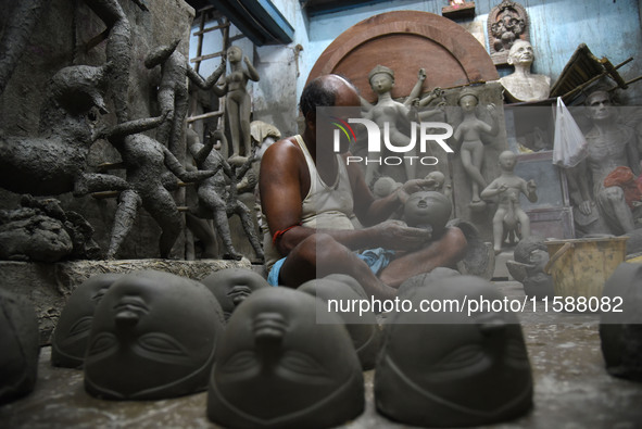 An artisan makes an idol of the Hindu Goddess Durga in Kumartuli, the potter's village in Kolkata, India, on September 20, 2024. The four-da...