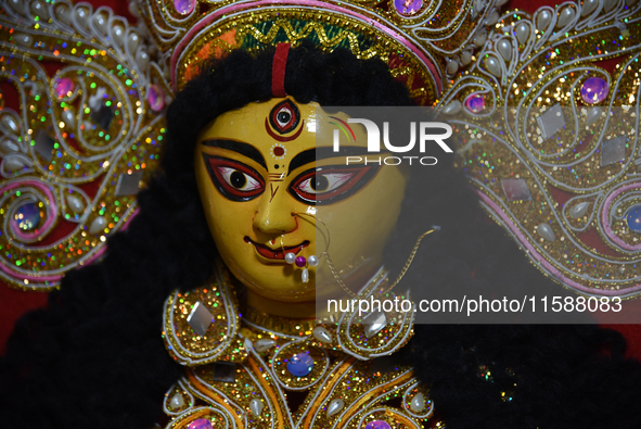 A decoration of the Hindu goddess Durga is displayed on a shelf inside a shop ahead of the Durga Puja festival in Kolkata, India, on Septemb...