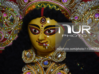 A decoration of the Hindu goddess Durga is displayed on a shelf inside a shop ahead of the Durga Puja festival in Kolkata, India, on Septemb...