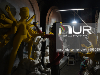 An artisan makes an idol of the Hindu Goddess Durga in Kumartuli, the potter's village in Kolkata, India, on September 20, 2024. The four-da...