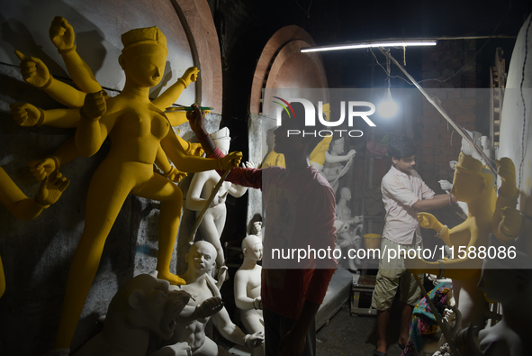 An artisan makes an idol of the Hindu Goddess Durga in Kumartuli, the potter's village in Kolkata, India, on September 20, 2024. The four-da...