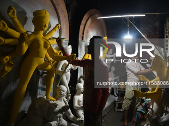 An artisan makes an idol of the Hindu Goddess Durga in Kumartuli, the potter's village in Kolkata, India, on September 20, 2024. The four-da...