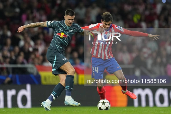 Benjamin Sesko centre-forward of RB Leipzig and Slovenia and Robin Le Normand centre-back of Atletico de Madrid and Spaincompete for the bal...