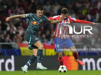 Benjamin Sesko centre-forward of RB Leipzig and Slovenia and Robin Le Normand centre-back of Atletico de Madrid and Spaincompete for the bal...