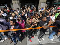 People demonstrate a simulation of rescuers and firefighters responding to an accident caused by the collapse of a building during the natio...